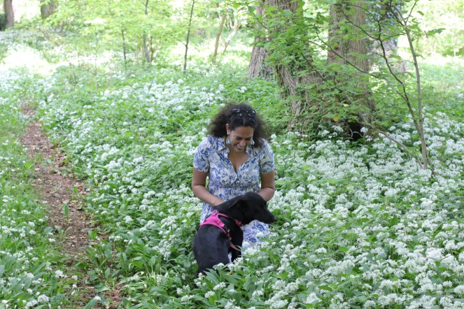 Abi in the garden sat in wild garlic in the Cotswolds