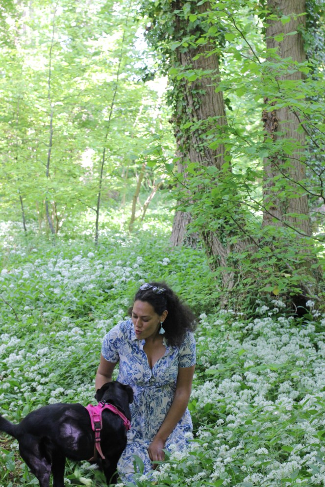 Abi in the garden sat in wild garlic in Broadway, Cotswolds