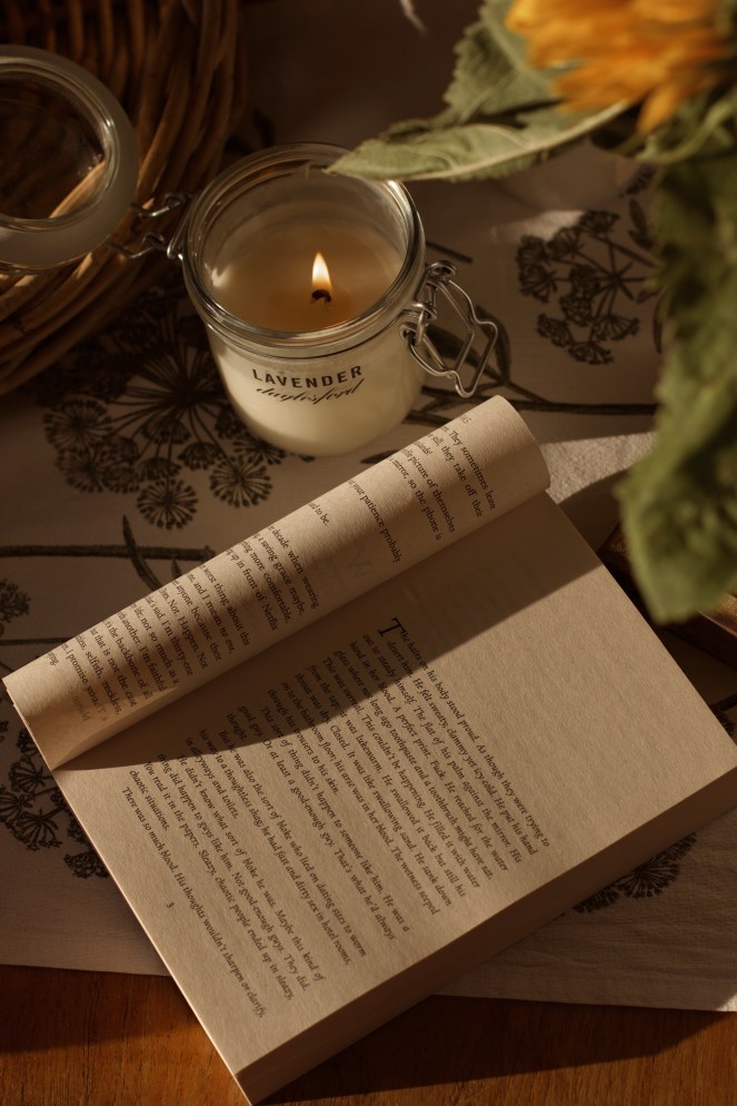 book and Daylesford lavender candle in the sunlight