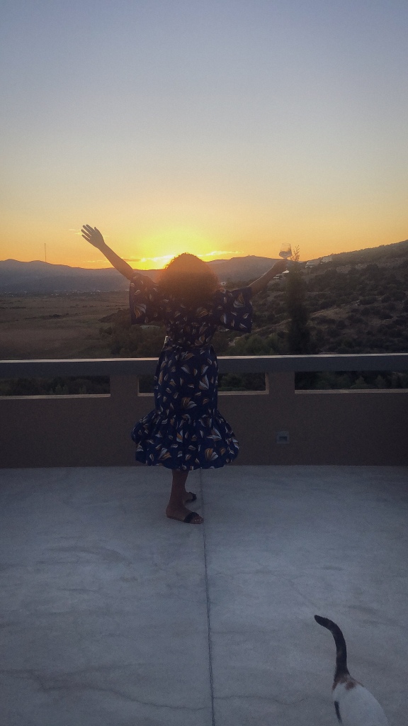 Abi on the VillaMarathon terrace as the sun goes down in a Kemi Telford dress
